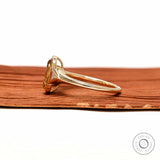 Side profile elongated champagne cushion ring with tapered triangle side stone