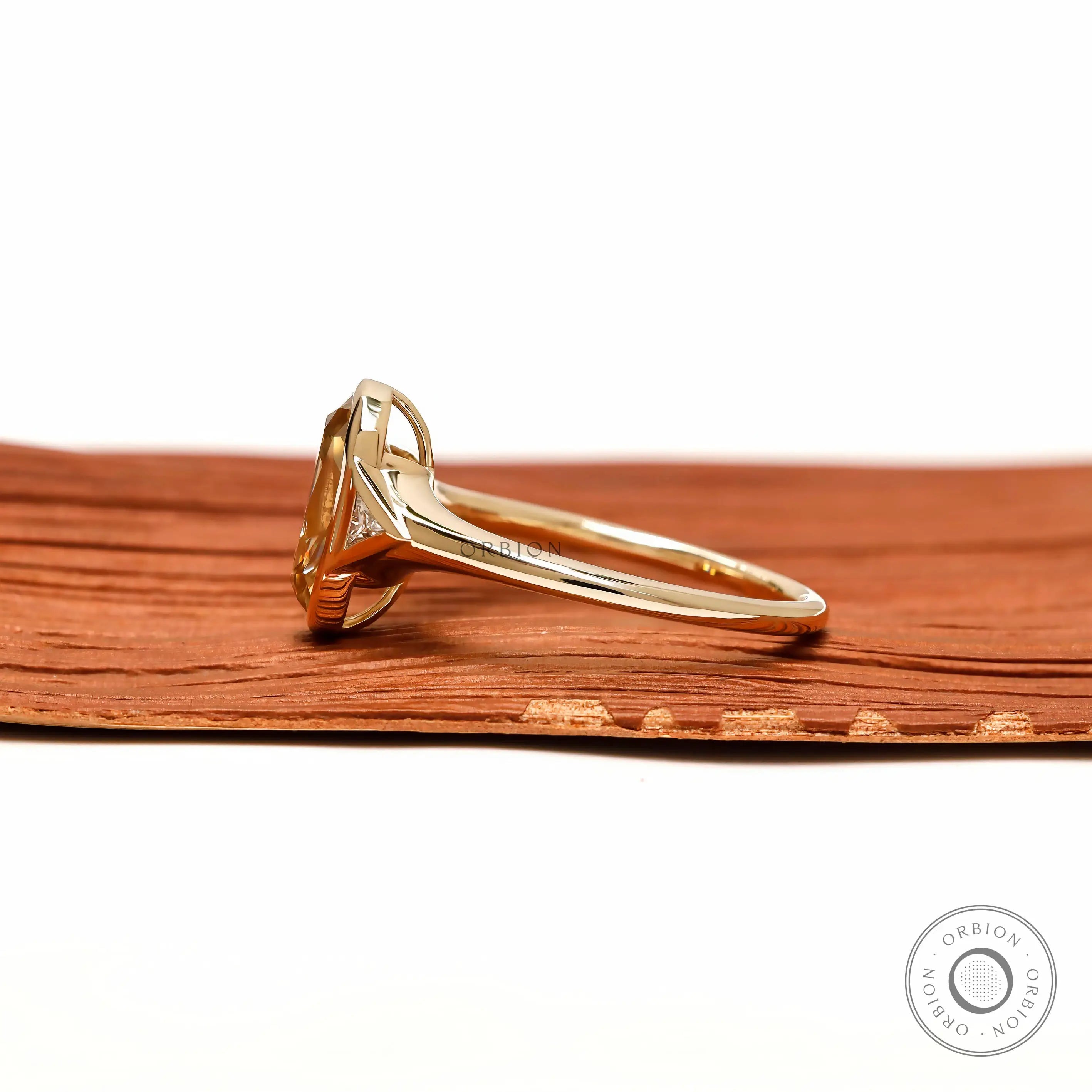 Side profile elongated champagne cushion ring with tapered triangle side stone