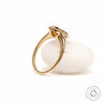 Side display view elongated cushion moissanite ring on white prop