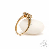 Side display view elongated cushion moissanite ring on white prop