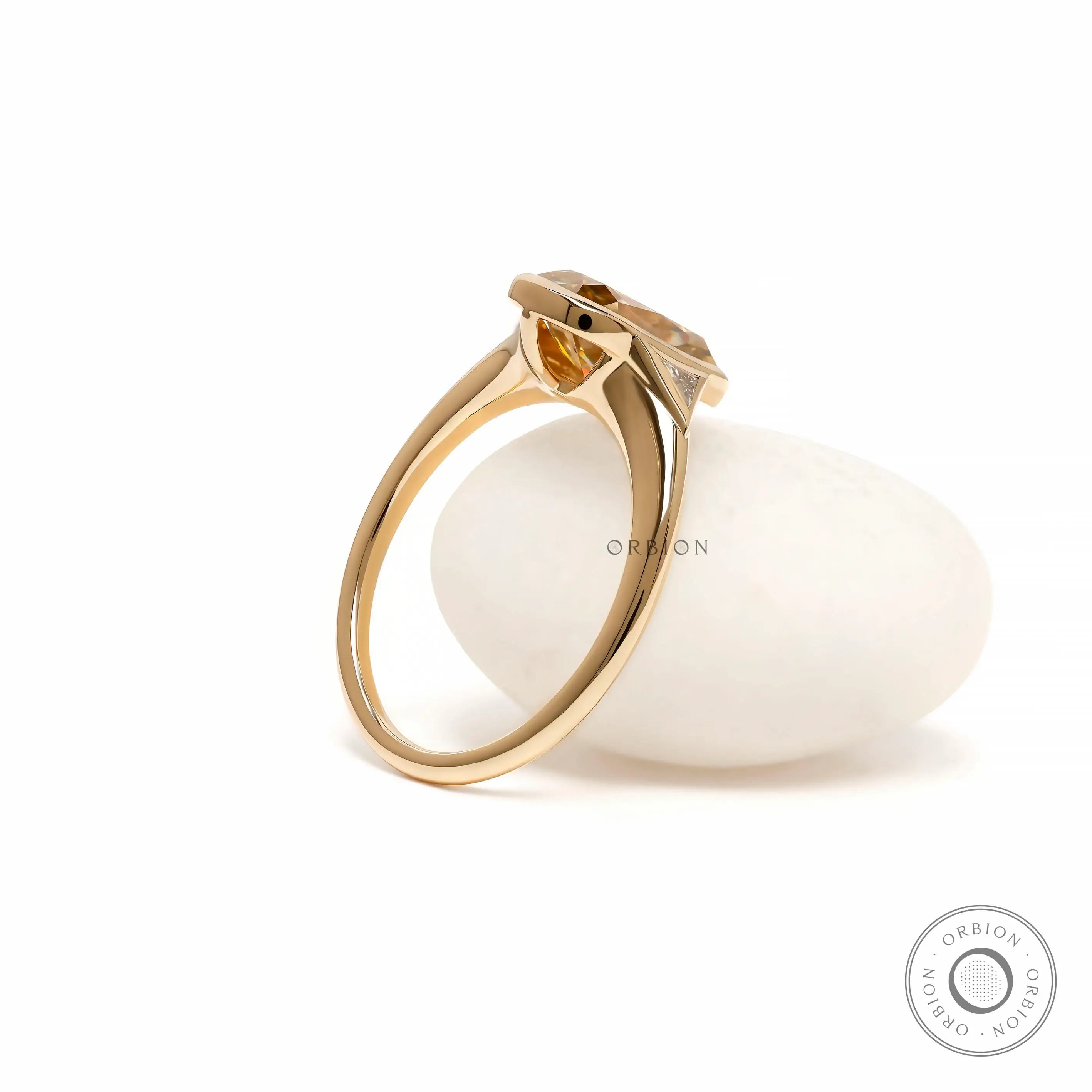 Side display view elongated cushion moissanite ring on white prop