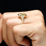Side hand view three stone champagne moissanite engagement ring