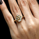 Angled top hand view elongated champagne cushion three stone ring