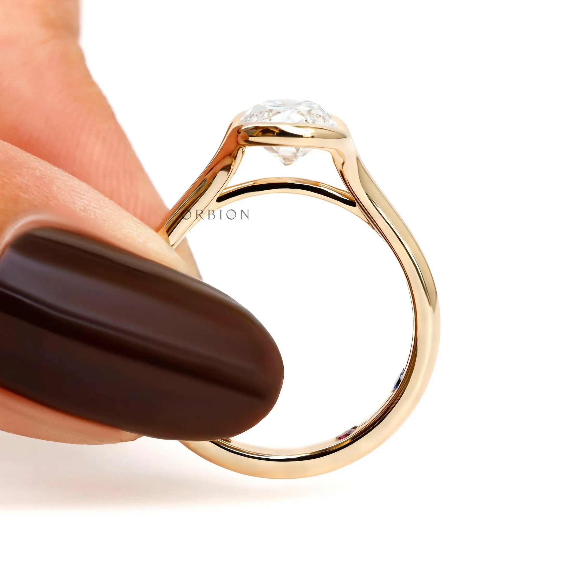 Finger held profile view elongated cushion lab diamond ring