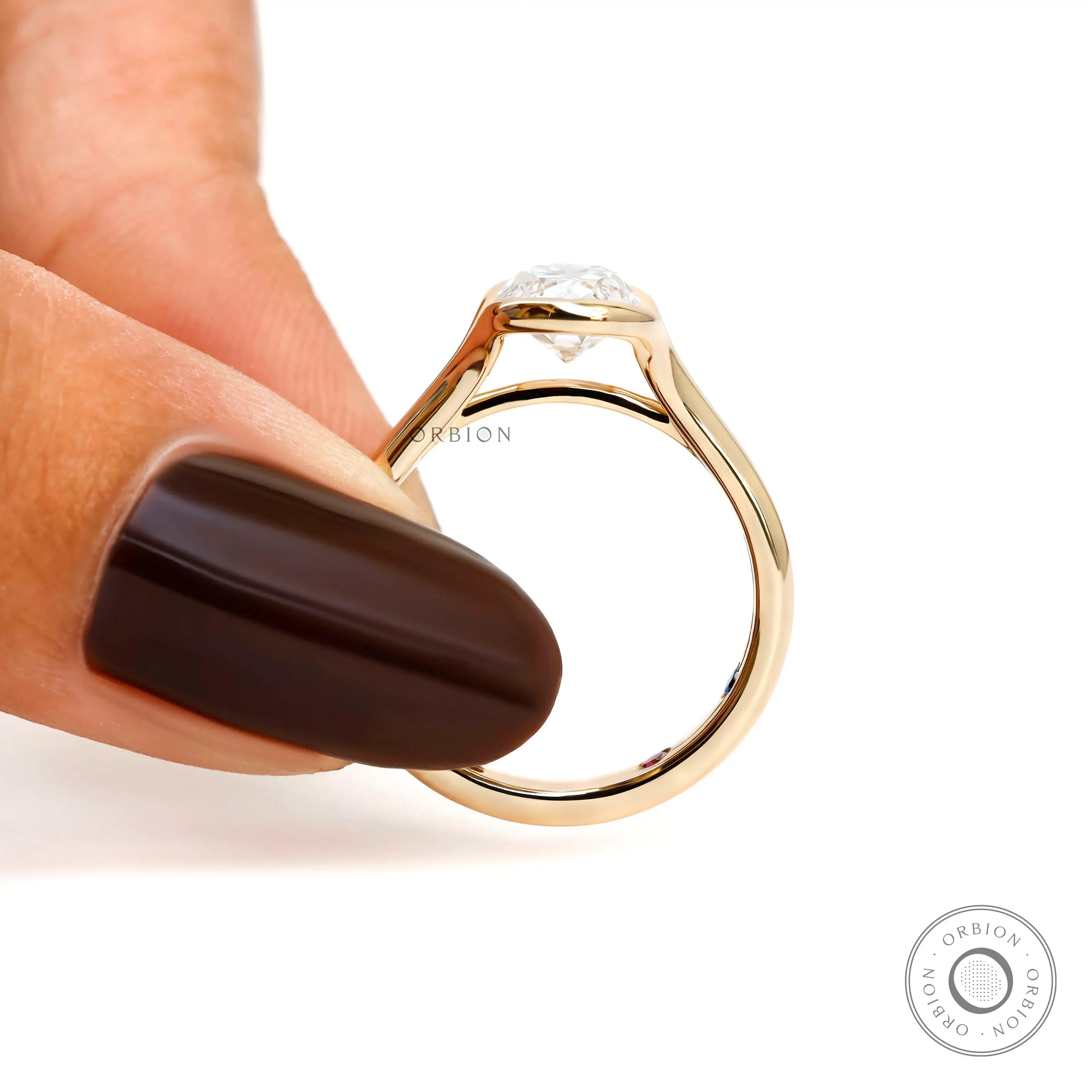 Finger held profile view elongated cushion lab diamond ring