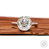 Front view round star cut diamond ring in floating bezel setting