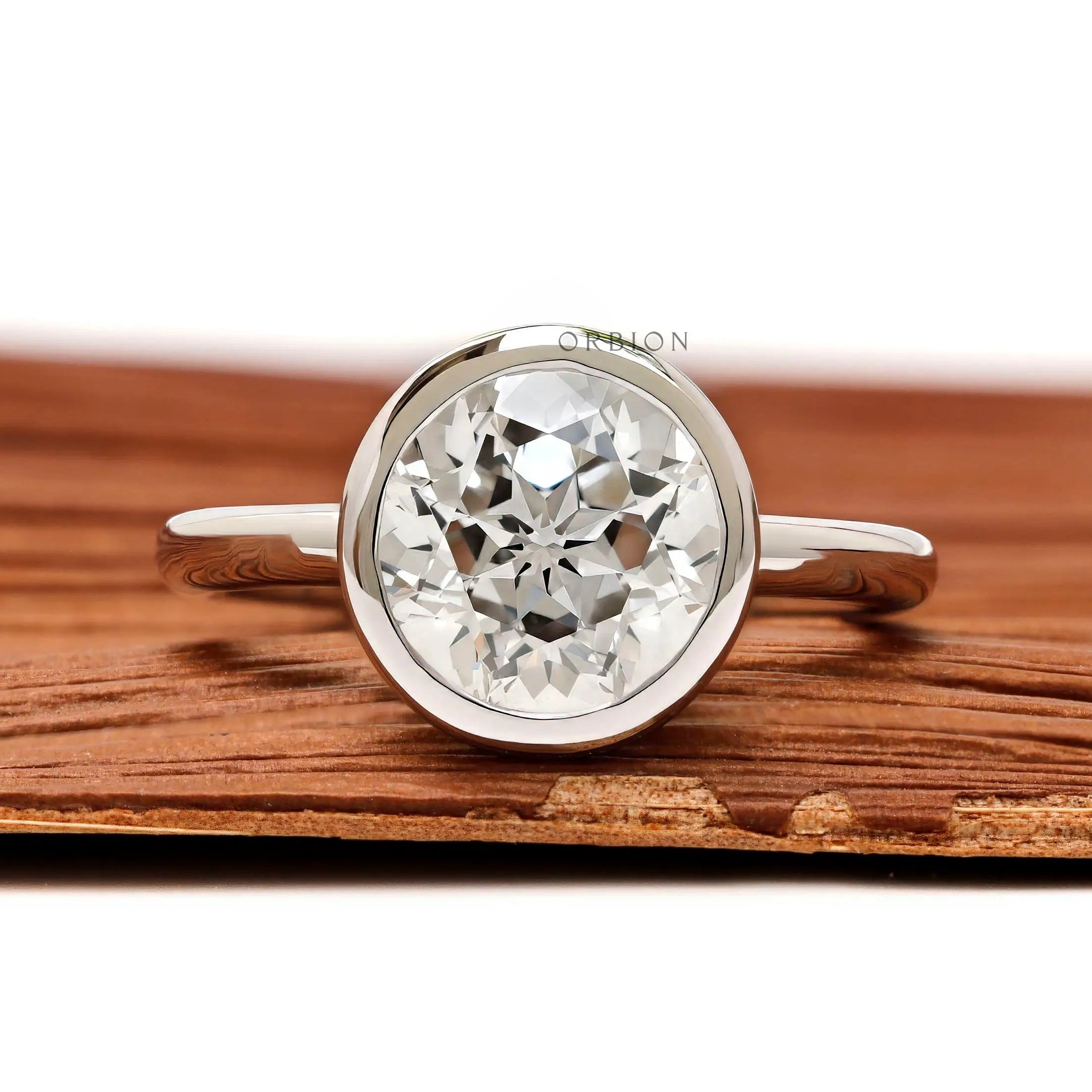 Front view round star cut diamond ring in floating bezel setting