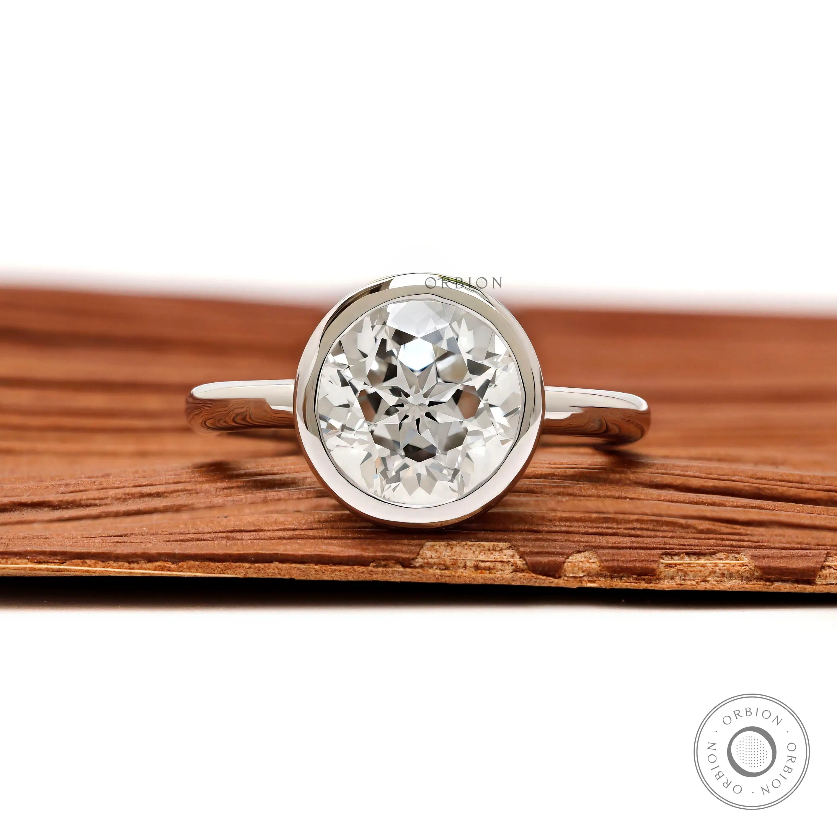 Front view round star cut diamond ring in floating bezel setting