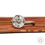 Angled front view bezel set round star cut diamond ring