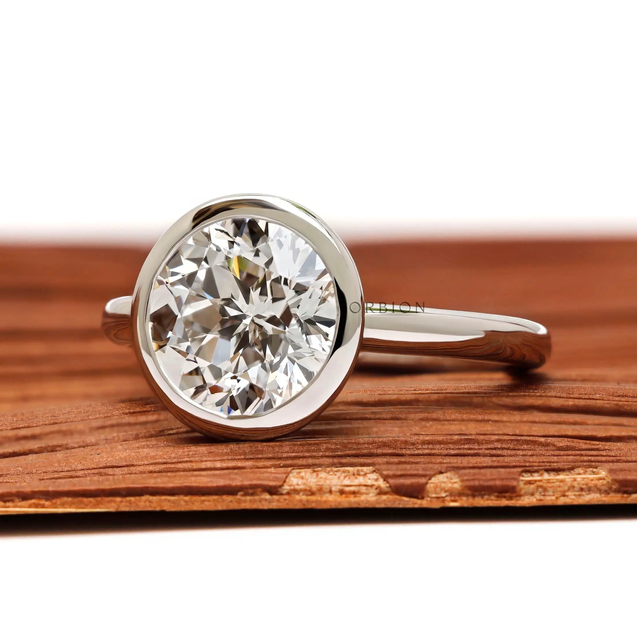 Angled front view bezel set round star cut diamond ring