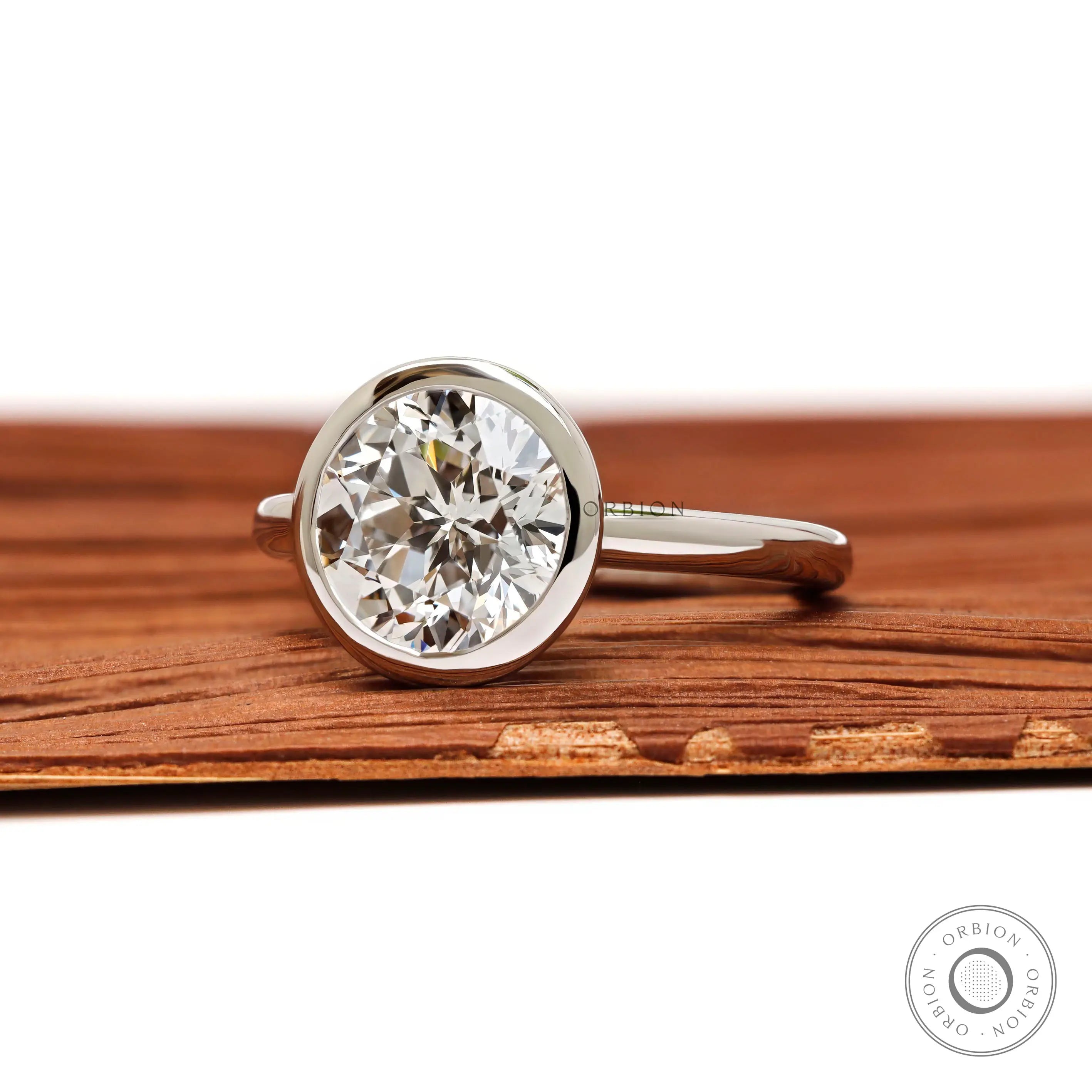 Angled front view bezel set round star cut diamond ring