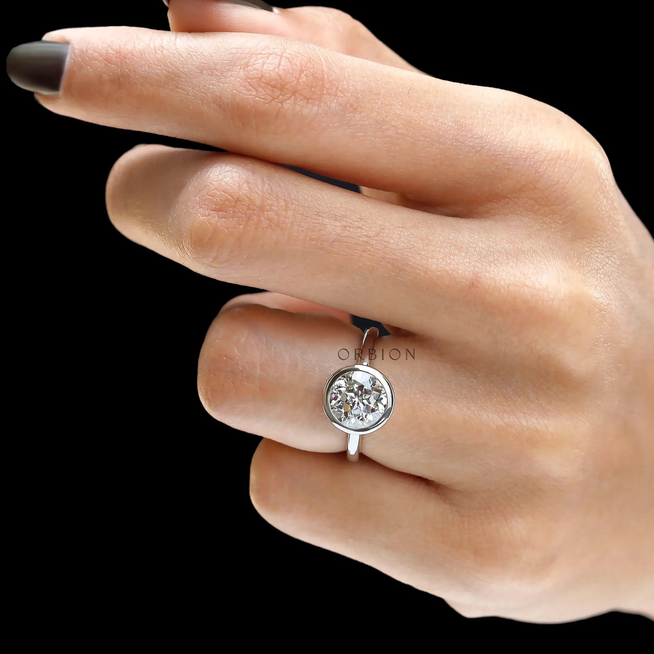 Full hand view floating bezel round diamond engagement ring
