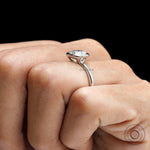 Side hand view elevated bezel set round diamond ring