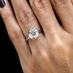 Close hand view round star cut bezel engagement ring