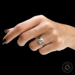 Angled hand view floating bezel round solitaire diamond ring