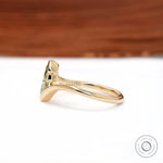 Side profile of dainty marquise lab diamond half bezel engagement ring.