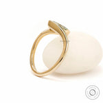 Back angle view of sculptural marquise lab diamond ring in yellow gold.