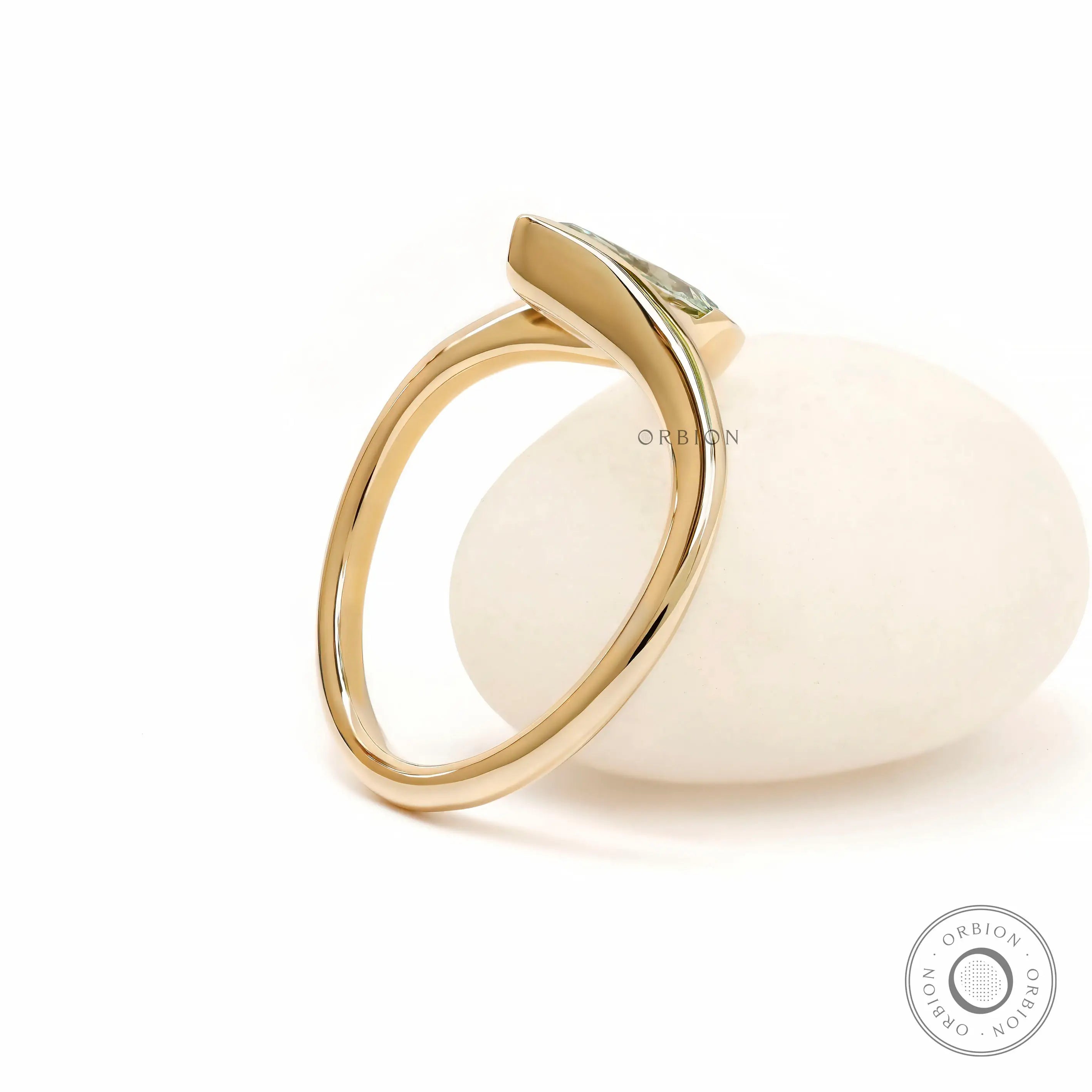 Back angle view of sculptural marquise lab diamond ring in yellow gold.