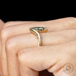 Side view of marquise lab diamond half bezel ring worn on hand.