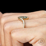 Side view of marquise lab diamond half bezel ring worn on hand.