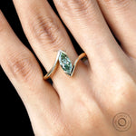 Close up of green marquise lab diamond engagement ring.