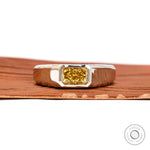 Front view platinum signet ring with east west radiant yellow lab diamond.