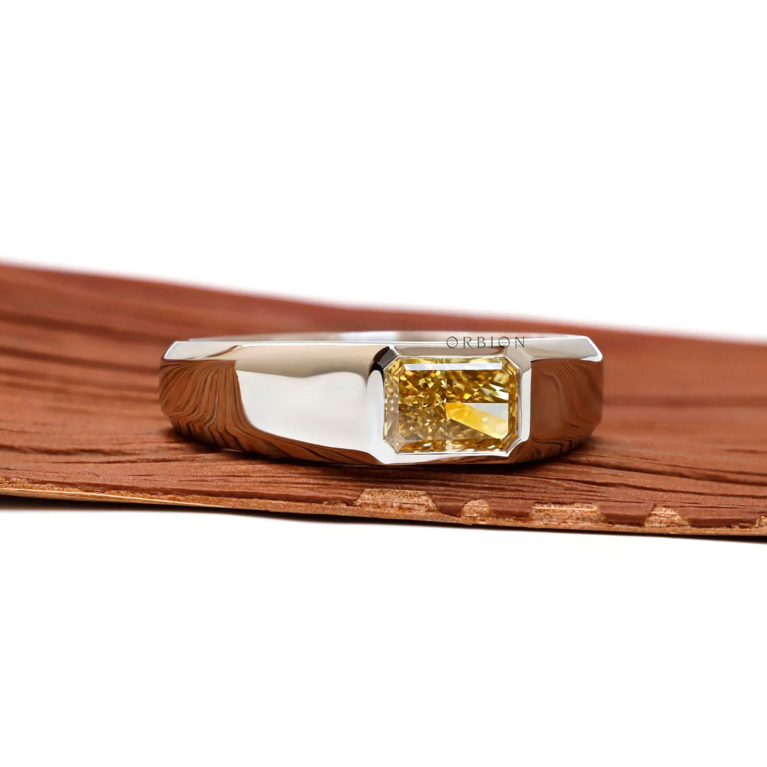 Angled front perspective showing radiant yellow diamond set in platinum.