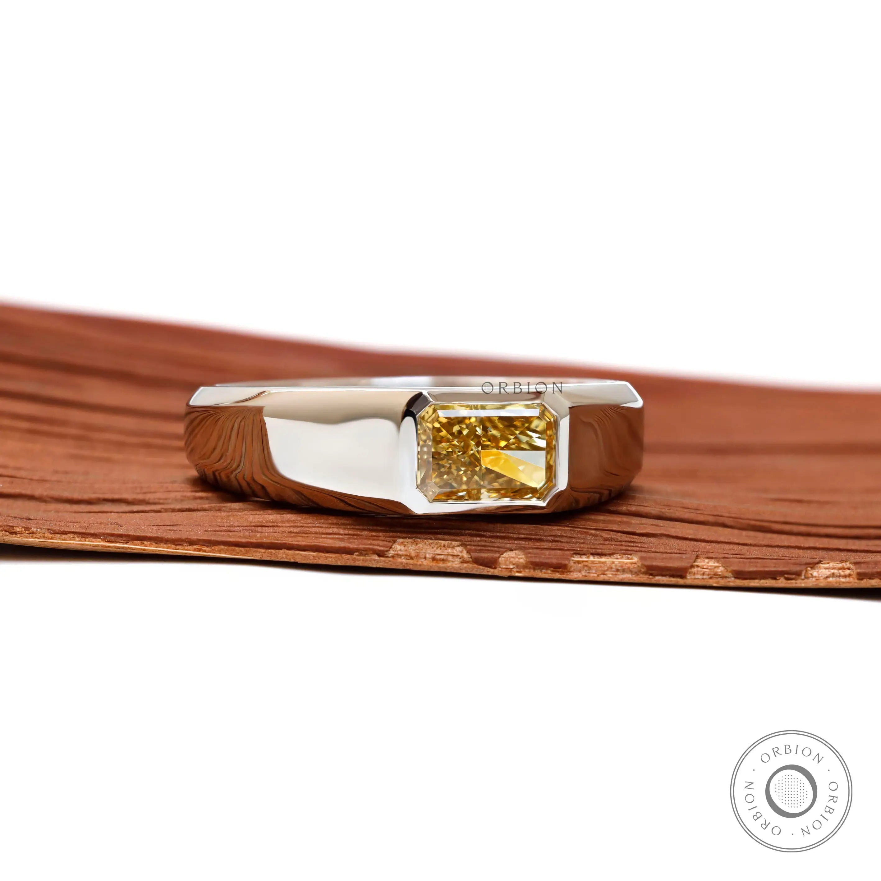Angled front perspective showing radiant yellow diamond set in platinum.