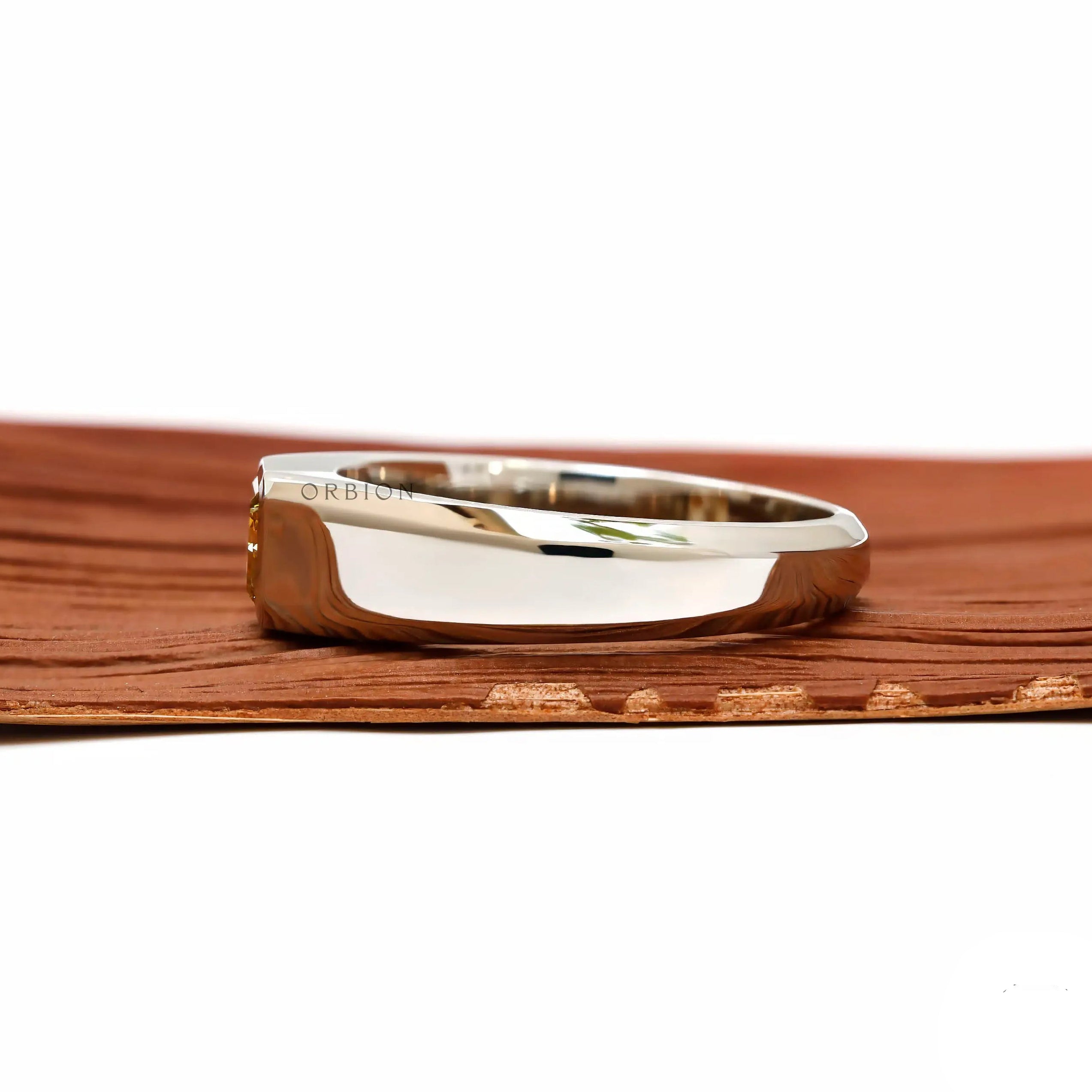 Side profile highlighting low profile platinum band and geometric setting.