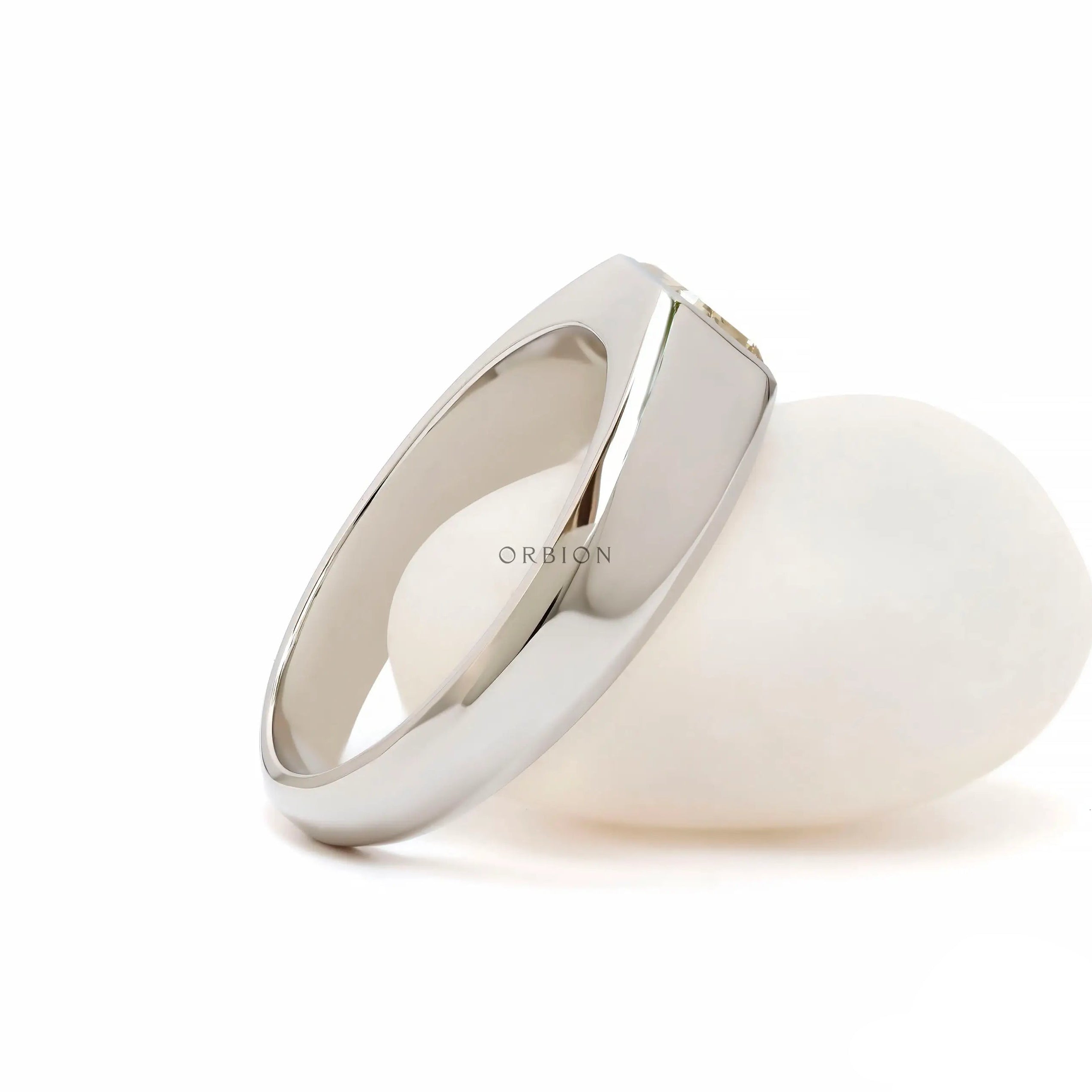 Rear angled view showing smooth tapered platinum signet band structure.