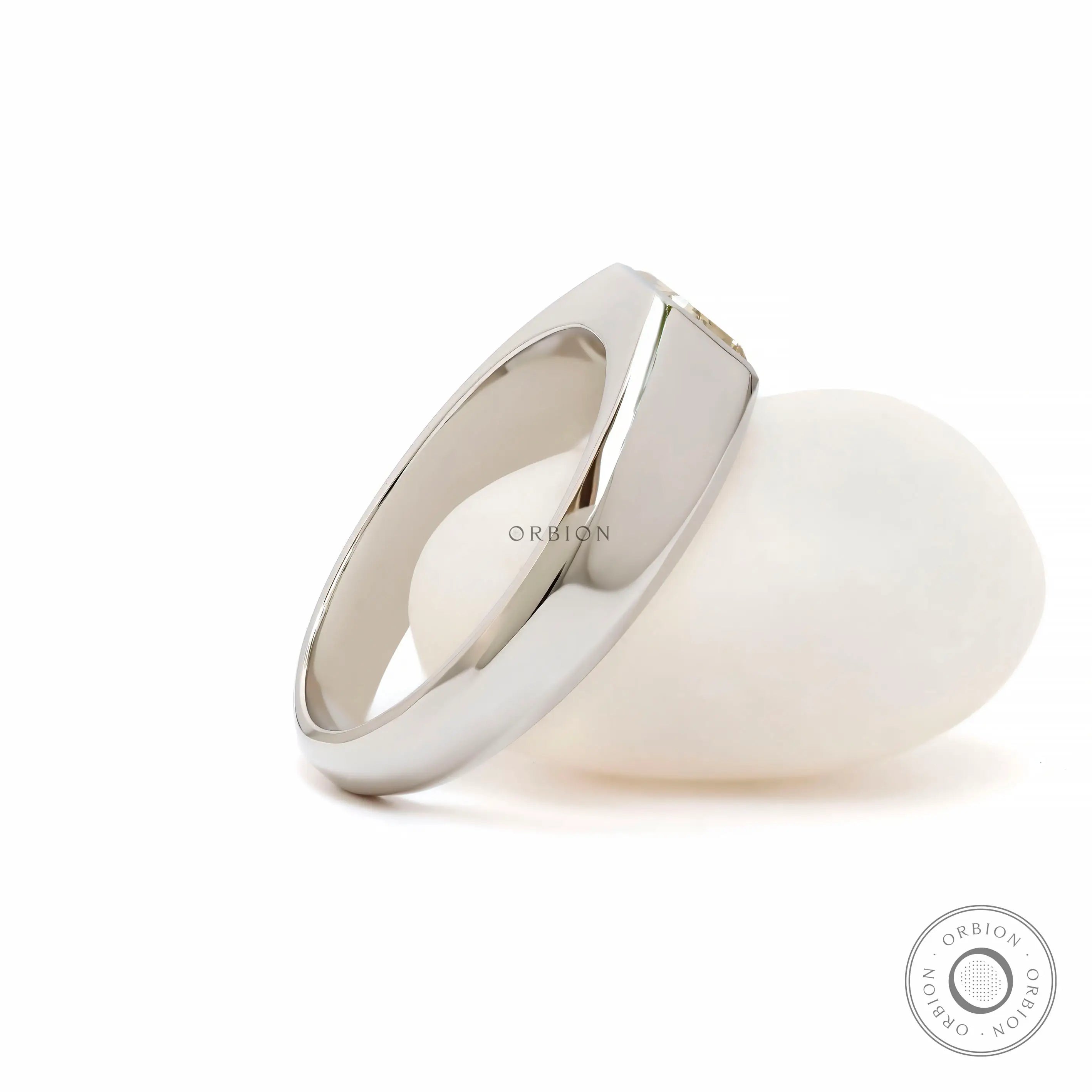 Rear angled view showing smooth tapered platinum signet band structure.