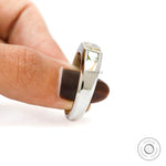Angled finger hold view emphasizing raised radiant diamond setting.