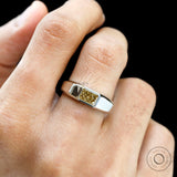 Front view of radiant yellow diamond platinum signet ring worn.