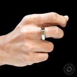 Hand shot displaying bold platinum signet ring with yellow diamond.