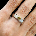 Close up worn view highlighting radiant yellow diamond center stone.