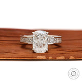 Centered view elongated cushion diamond engagement ring with princess accents.