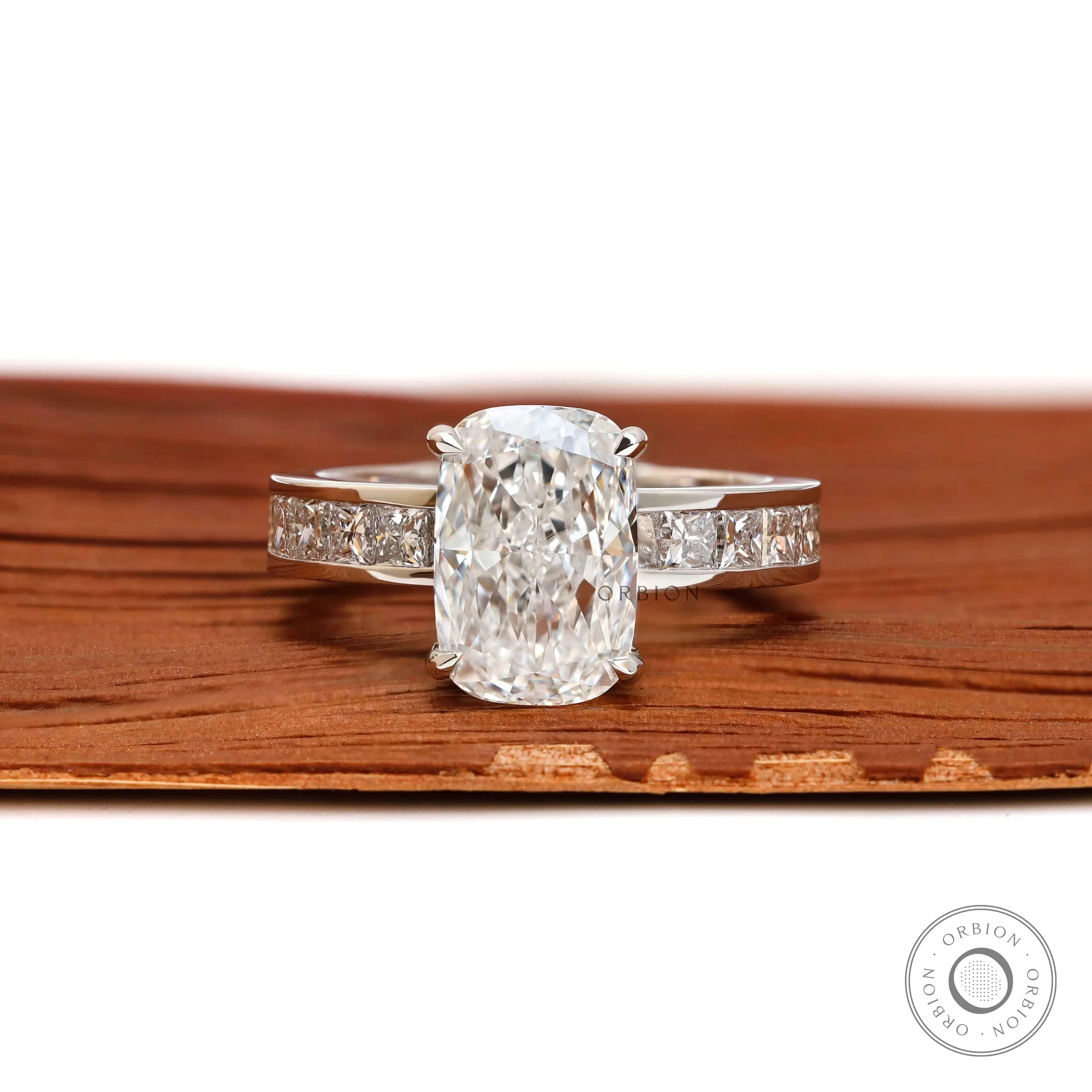Centered view elongated cushion diamond engagement ring with princess accents.