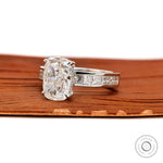 Angled perspective elongated cushion diamond ring with channel set shoulders.