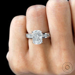 Close worn view elongated cushion diamond ring with channel band.
