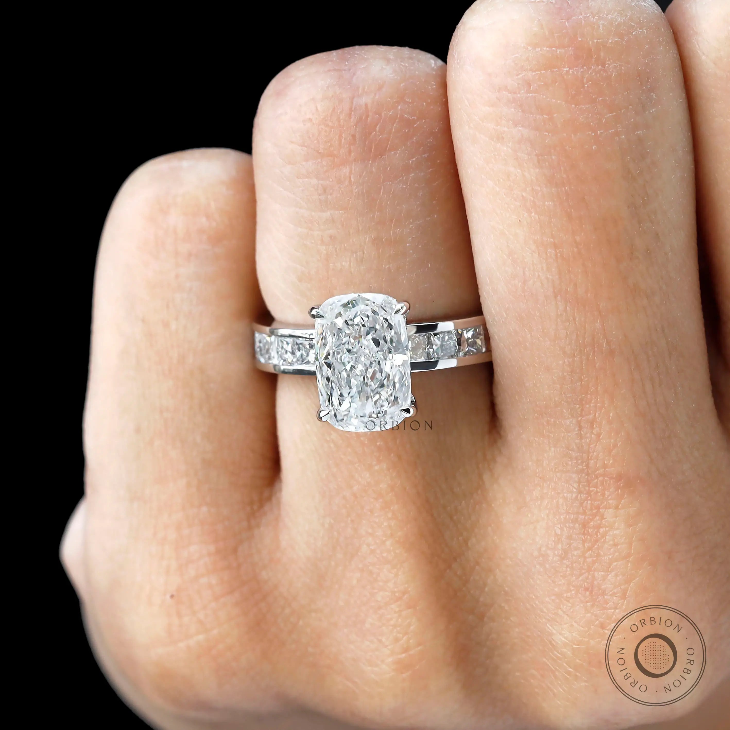 Close worn view elongated cushion diamond ring with channel band.