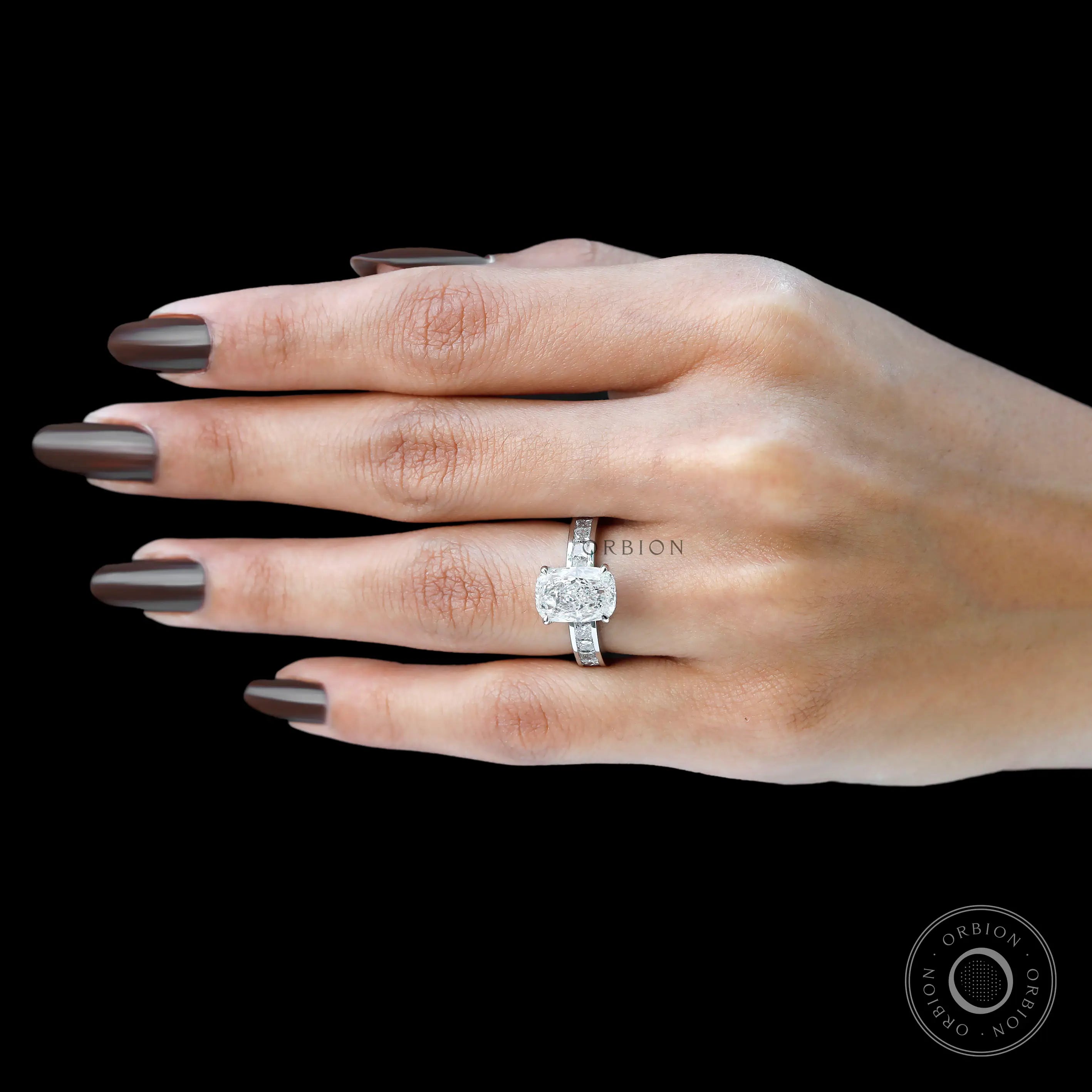 Hand view displaying elongated cushion diamond engagement ring design.