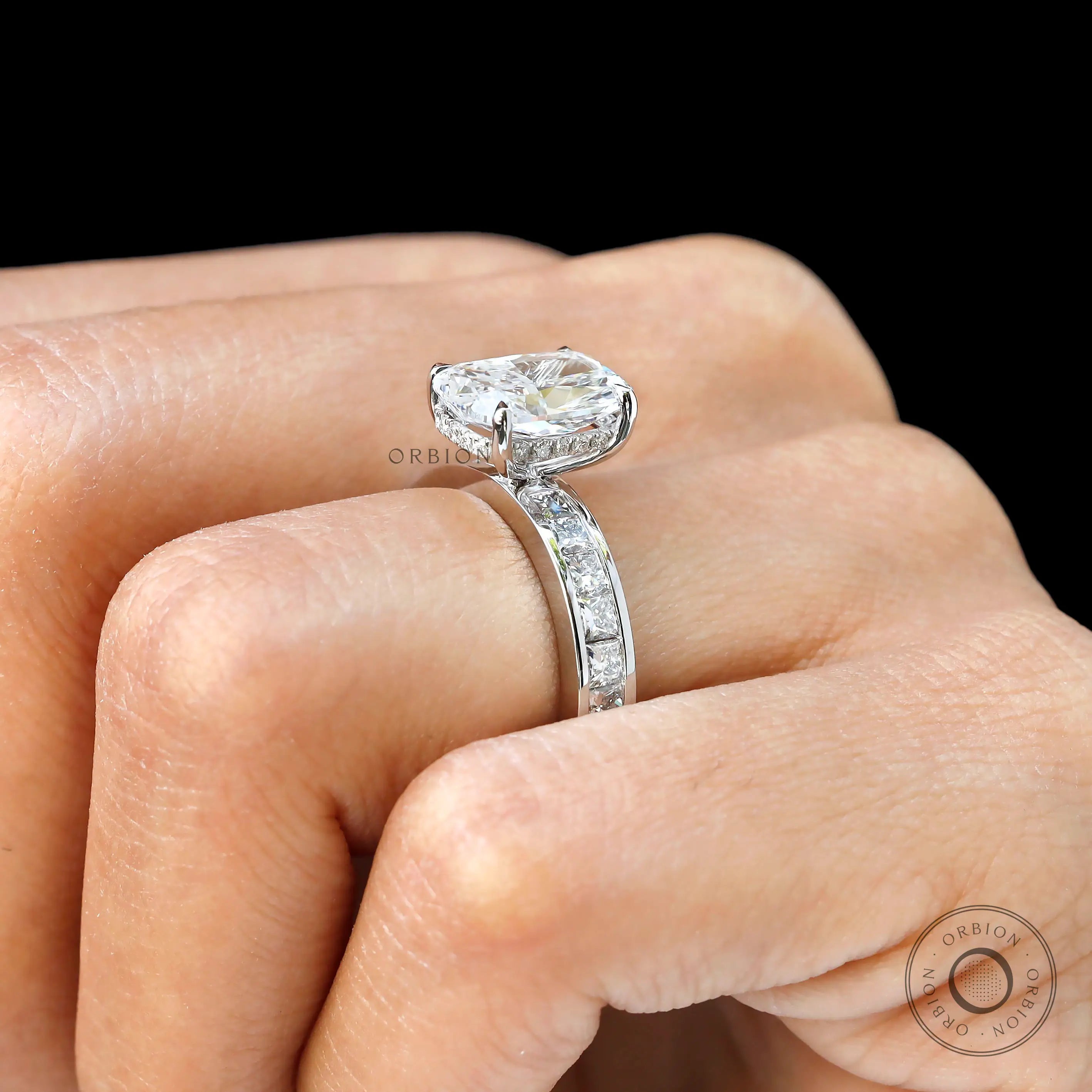 Worn side angle highlighting hidden halo and elevated diamond setting.
