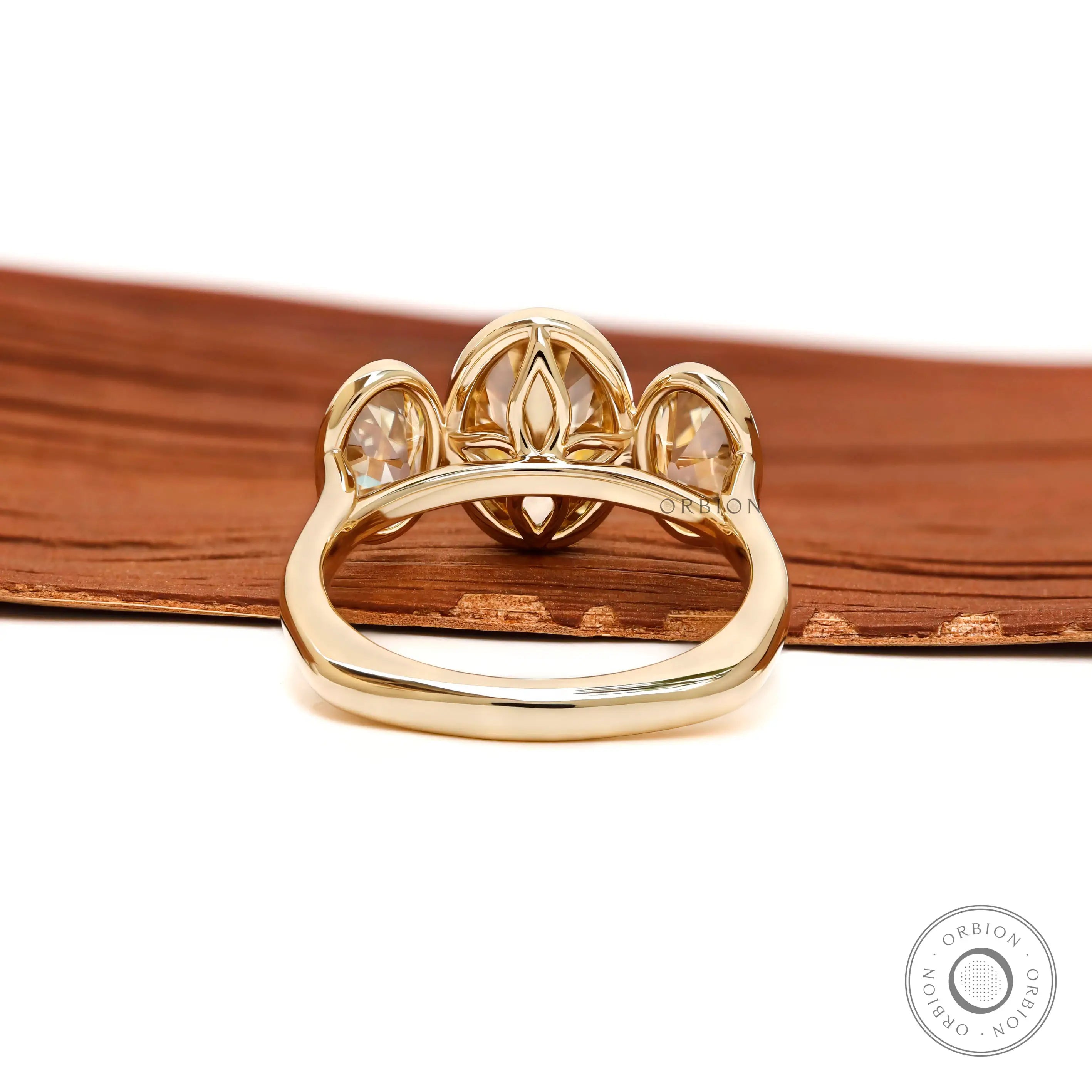 Back view revealing open gallery beneath three bezel set stones.