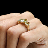 Worn side view of bezel set three stone oval ring.