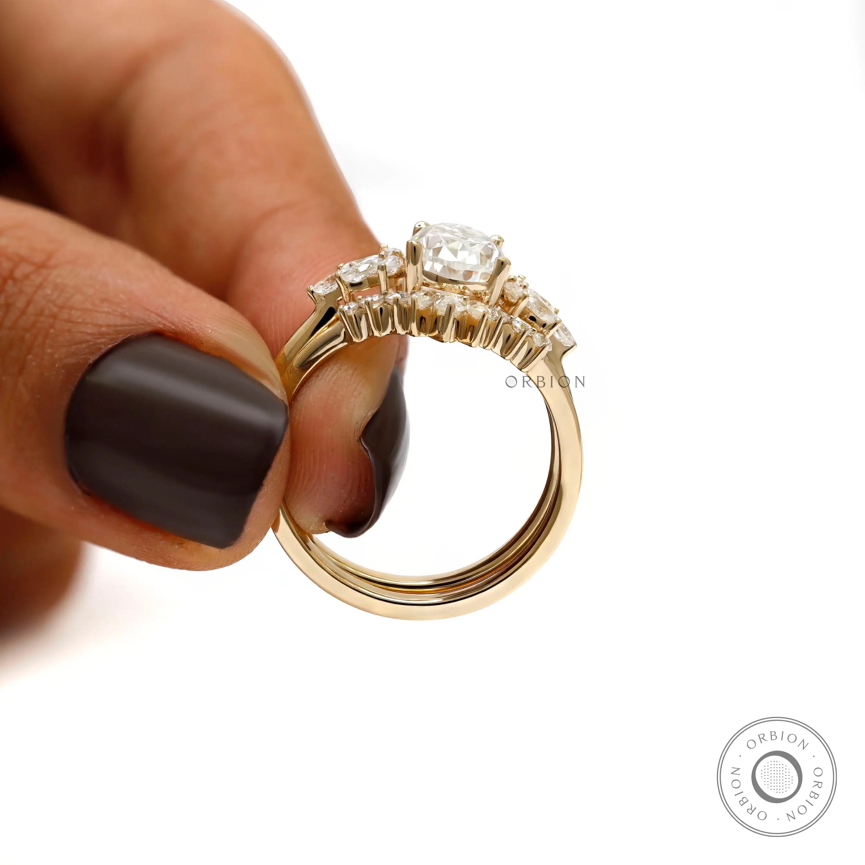Detailed side view of stacked pear moissanite ring set