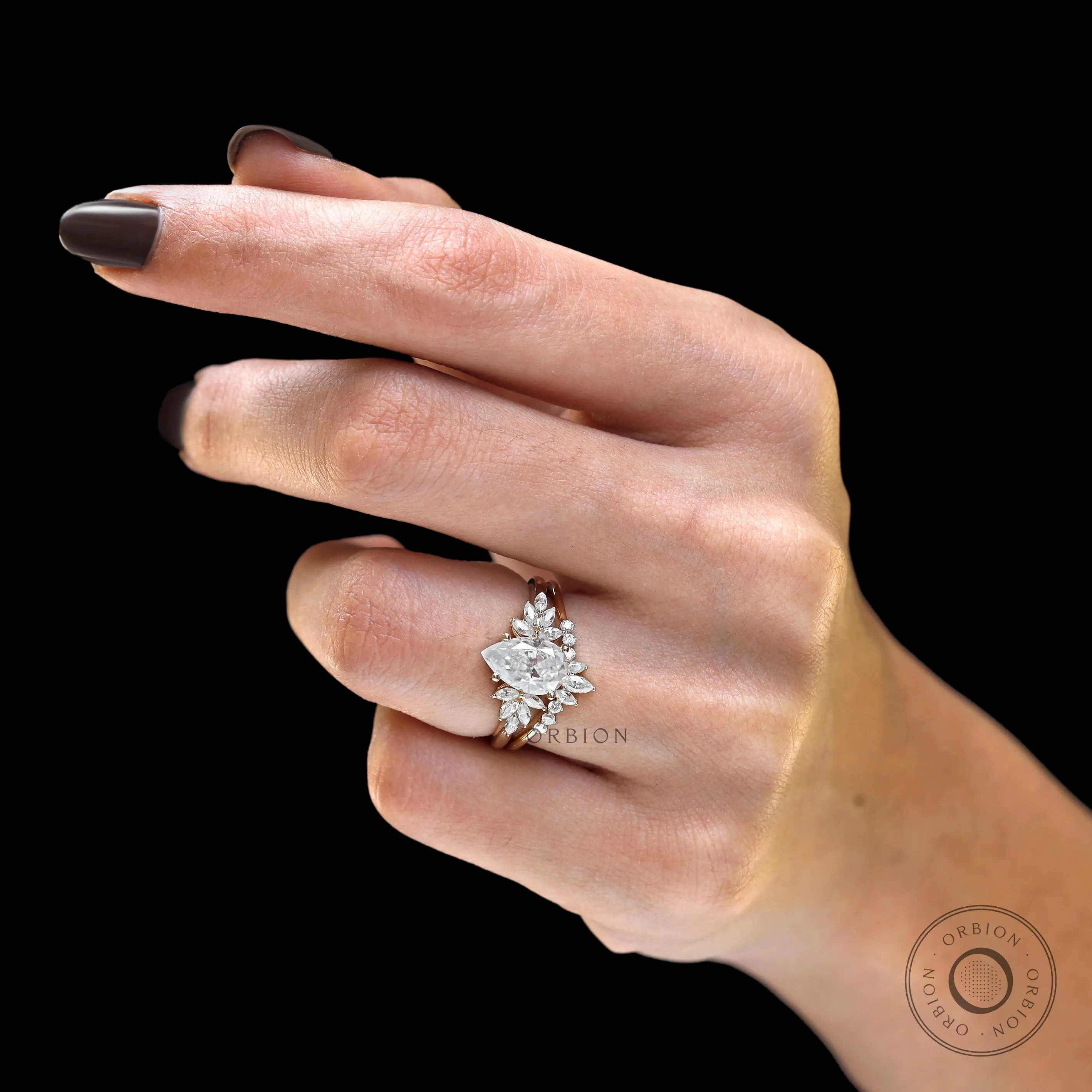 Close hand view of pear moissanite floral ring set