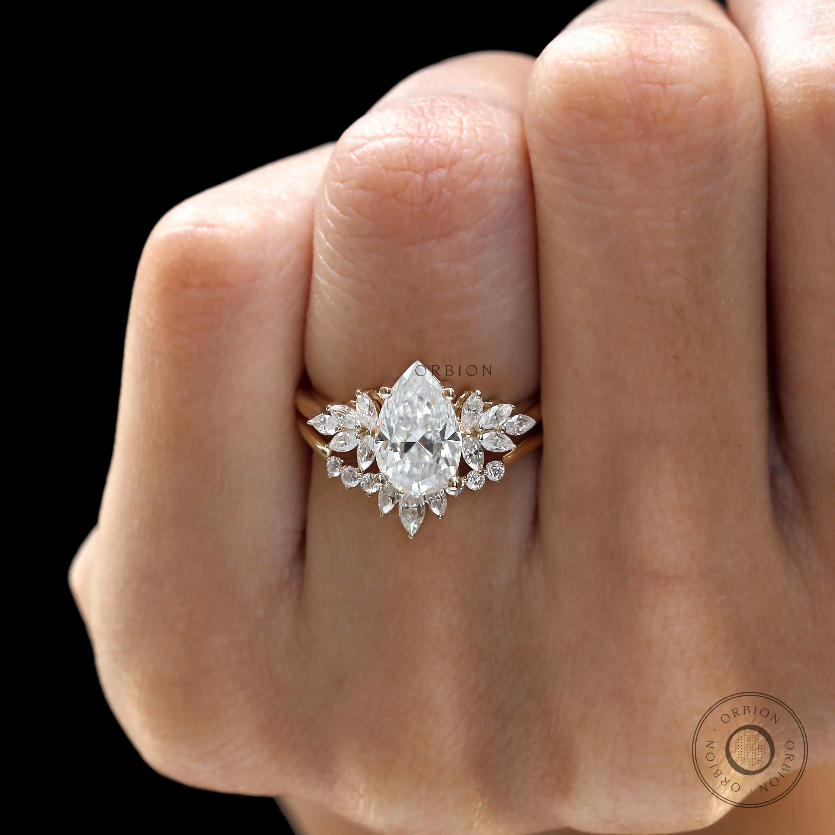 Display view of pear moissanite ring set with curved band