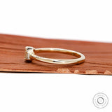 Side profile showing slim yellow gold band and low setting.