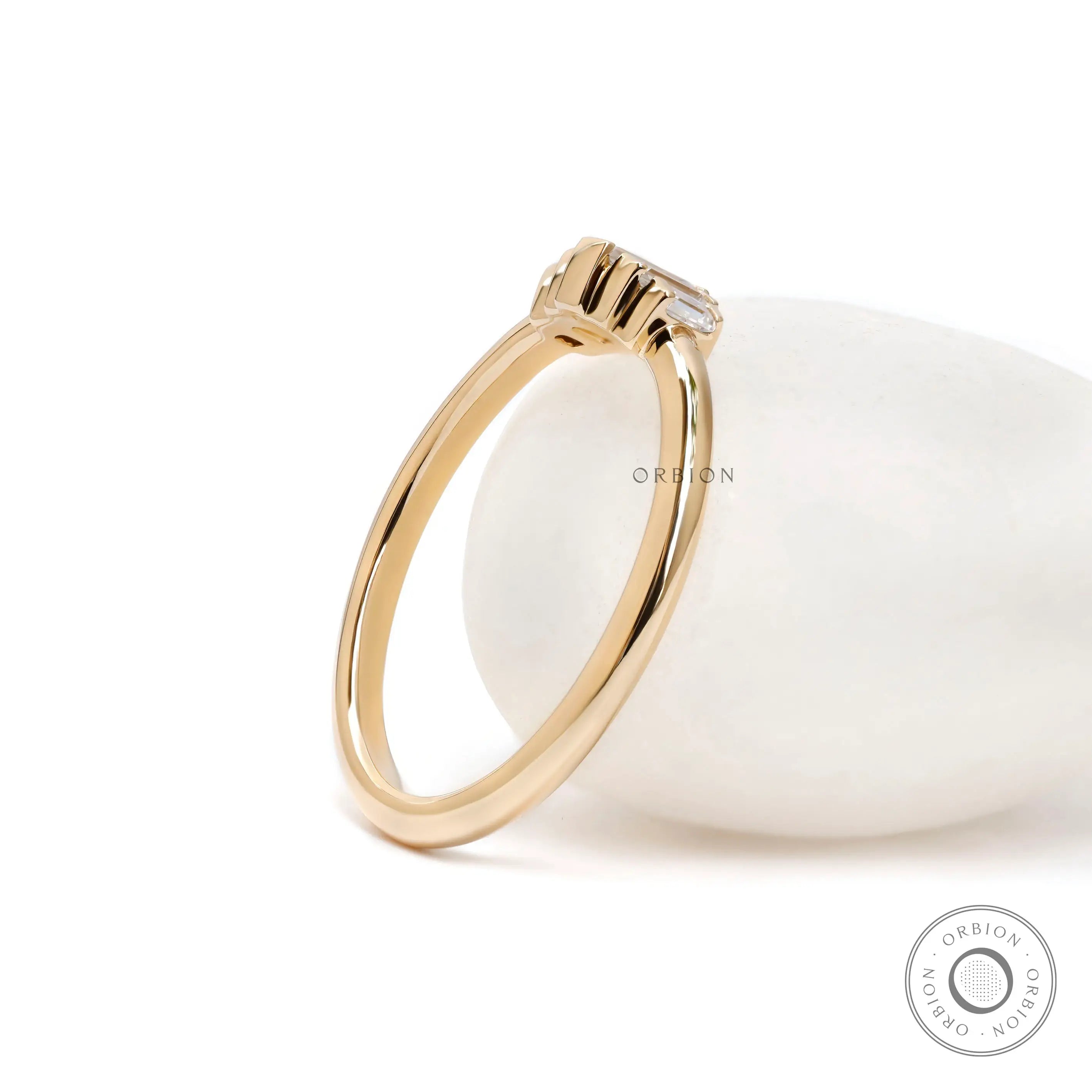 Back angled view of polished yellow gold band with minimal silhouette.