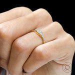 Worn side view showing slim profile of five stone baguette ring.